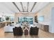 Spacious living room with stone accent wall, beamed ceiling, and comfortable seating at 9352 Santorini Dr, Orlando, FL 32827