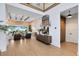 Open-concept living room featuring exposed beams, stone accent wall, and views of backyard pool at 9352 Santorini Dr, Orlando, FL 32827