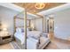 Relaxing main bedroom featuring a four-poster bed, accent lighting, and a view into the hallway at 9352 Santorini Dr, Orlando, FL 32827
