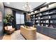 Stylish home office featuring a custom desk, a bookshelf, and ample natural light at 9352 Santorini Dr, Orlando, FL 32827