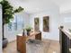 Bright office space features a wooden desk, stylish decor, and large windows, offering a productive and inviting work environment at 9352 Santorini Dr, Orlando, FL 32827