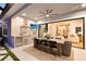 Outdoor kitchen under a covered patio has a grill, stainless appliances, dining table, and elegant chandelier at 9352 Santorini Dr, Orlando, FL 32827