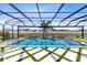 Stunning pool and spa with basketball hoop and waterfall feature in a screened enclosure at 9352 Santorini Dr, Orlando, FL 32827