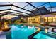 Screened-in pool area featuring a fire pit, outdoor kitchen, and comfortable seating at 9352 Santorini Dr, Orlando, FL 32827