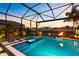 Inviting pool and spa with fire feature in screened lanai overlooking water at 9352 Santorini Dr, Orlando, FL 32827