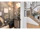 Stylish powder room featuring nature-inspired wallpaper, dark fixtures, and a modern staircase at 9352 Santorini Dr, Orlando, FL 32827