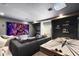 Entertainment room with comfy seating, big screen, and air hockey table offers a fun and relaxing space for movie nights at 9352 Santorini Dr, Orlando, FL 32827