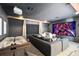 Entertainment room features a large screen, comfortable seating, and an air hockey table, offering a fun and relaxing space at 9352 Santorini Dr, Orlando, FL 32827