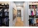 Spacious and walk-in closet with custom shelving and seamless access to the bathroom at 9352 Santorini Dr, Orlando, FL 32827
