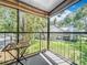 Balcony featuring an outdoor table and chairs, and a view of the community's lush landscaping at 950 Bird Bay Ct # 206, Lake Mary, FL 32746