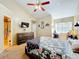 Bedroom featuring high ceilings, a ceiling fan, modern rustic furniture, and carpeted floors at 950 Bird Bay Ct # 206, Lake Mary, FL 32746