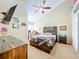 Bedroom featuring high ceilings, a ceiling fan, modern rustic furniture, and carpeted floors at 950 Bird Bay Ct # 206, Lake Mary, FL 32746