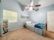 Bedroom featuring a window providing natural light, a ceiling fan, and carpeted floors at 950 Bird Bay Ct # 206, Lake Mary, FL 32746