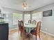 Bright dining room with wood floors, bright windows, ceiling fan, and space for six at 950 Bird Bay Ct # 206, Lake Mary, FL 32746