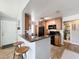 Open kitchen with granite countertops, breakfast bar, wood cabinets, and black appliances at 950 Bird Bay Ct # 206, Lake Mary, FL 32746