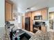 Close up view of the kitchen featuring a black oven, microwave and refrigerator and granite countertops at 950 Bird Bay Ct # 206, Lake Mary, FL 32746