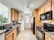 The kitchen offers granite countertops, black appliances and wood laminate flooring at 950 Bird Bay Ct # 206, Lake Mary, FL 32746