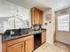 Spacious kitchen with wood cabinets, granite counters, stainless steel appliances and open layout to the living area at 950 Bird Bay Ct # 206, Lake Mary, FL 32746
