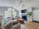 Bright living room with a fireplace, ceiling fan, and large windows at 950 Bird Bay Ct # 206, Lake Mary, FL 32746