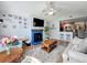 Open-concept living room with a fireplace, adjacent to the kitchen at 950 Bird Bay Ct # 206, Lake Mary, FL 32746