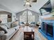 Bright living room boasts vaulted ceilings, a fireplace, and large windows at 950 Bird Bay Ct # 206, Lake Mary, FL 32746