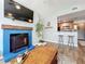 Bright living room features a blue fireplace and mantle, vaulted ceilings, and an open bar to the kitchen at 950 Bird Bay Ct # 206, Lake Mary, FL 32746
