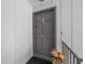 Condo front door adorned with seasonal flowers on a small landing at 1000 S Semoran Blvd # 604, Winter Park, FL 32792