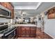 Open kitchen with granite countertops and a view of the living room at 1000 S Semoran Blvd # 604, Winter Park, FL 32792