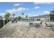 Community pool surrounded by tables and chairs for residents to enjoy at 1000 S Semoran Blvd # 604, Winter Park, FL 32792