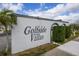 Community sign that reads 'Golfside Villas' near sidewalk and landscaping at 1000 S Semoran Blvd # 604, Winter Park, FL 32792