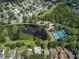 Community aerial view showcasing a pond, pool, basketball court and homes at 1010 Leinhart Ct, Oviedo, FL 32765