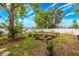 Spacious backyard with garden beds, and lush landscaping, providing a serene outdoor space at 1010 Leinhart Ct, Oviedo, FL 32765