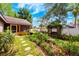 Serene backyard with bird bath, covered seating area, swing and meticulous landscaping at 1010 Leinhart Ct, Oviedo, FL 32765