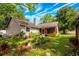 This backyard has a patio, a grill, lush landscaping and is surrounded by trees at 1010 Leinhart Ct, Oviedo, FL 32765