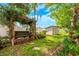Secluded backyard with wooden swing, wooden shed, and meticulous landscaping at 1010 Leinhart Ct, Oviedo, FL 32765