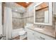 This bathroom has a vanity, tiled walls and shower/tub, and a light wood paneled ceiling at 1010 Leinhart Ct, Oviedo, FL 32765