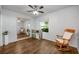 This bedroom showcases hardwood floors, a ceiling fan, a large mirror, and natural light from the window at 1010 Leinhart Ct, Oviedo, FL 32765