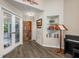 This entryway has hardwood floors, a wood front door and a small nook with books at 1010 Leinhart Ct, Oviedo, FL 32765