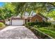 Charming single-story home with brick and siding, mature landscaping, and a two-car garage at 1010 Leinhart Ct, Oviedo, FL 32765