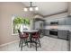 Eat-in kitchen featuring stainless steel appliances, gray cabinets, and a bright window at 1010 Leinhart Ct, Oviedo, FL 32765