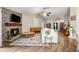 Inviting living room featuring a stone fireplace, wood floors, and a comfortable white sofa at 1010 Leinhart Ct, Oviedo, FL 32765