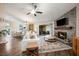 Spacious living room with stone fireplace, wood floors, and sliding glass doors to a lanai at 1010 Leinhart Ct, Oviedo, FL 32765