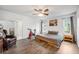 Bright main bedroom with wood floors, a ceiling fan, and views of the yard at 1010 Leinhart Ct, Oviedo, FL 32765