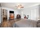 Spacious main bedroom with wood floors, a ceiling fan, and access to ensuite bathroom at 1010 Leinhart Ct, Oviedo, FL 32765