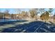 Community tennis court with basketball hoop providing recreational opportunities for residents at 1010 Leinhart Ct, Oviedo, FL 32765