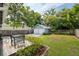 Backyard features a detached two-car garage, deck, and lush green lawn at 112 E Spruce St, Orlando, FL 32804