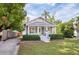 Quaint single-story home boasting a lush lawn and a welcoming front porch with a bright green door at 112 E Spruce St, Orlando, FL 32804
