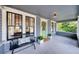 Cozy front porch with a bench, greenery, and beadboard ceiling detail at 112 E Spruce St, Orlando, FL 32804