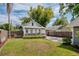 Charming home features a manicured lawn, cozy front porch, green door, and driveway at 112 E Spruce St, Orlando, FL 32804
