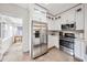 Modern kitchen features stainless steel appliances and white cabinetry and adjacent breakfast nook at 112 E Spruce St, Orlando, FL 32804